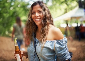 Aphrodite...Portrait of a pretty young woman enjoying a drink at an outdoors music festival